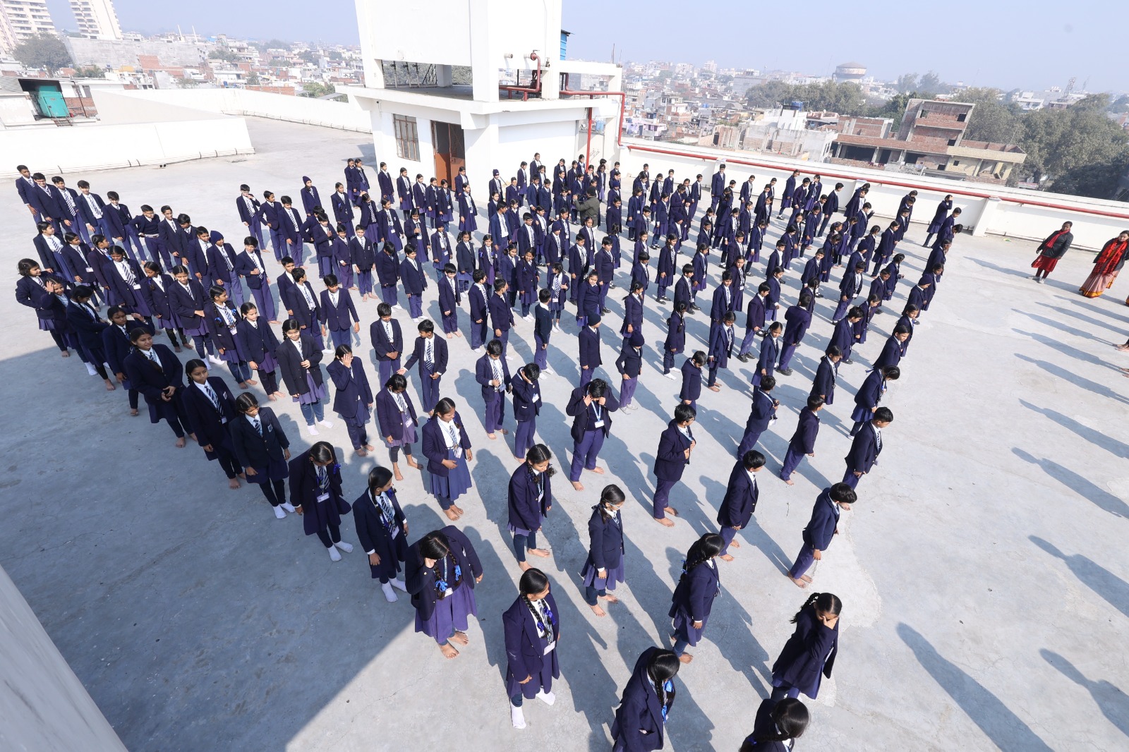 Students standing at attention in disciplined rows during morning assembly