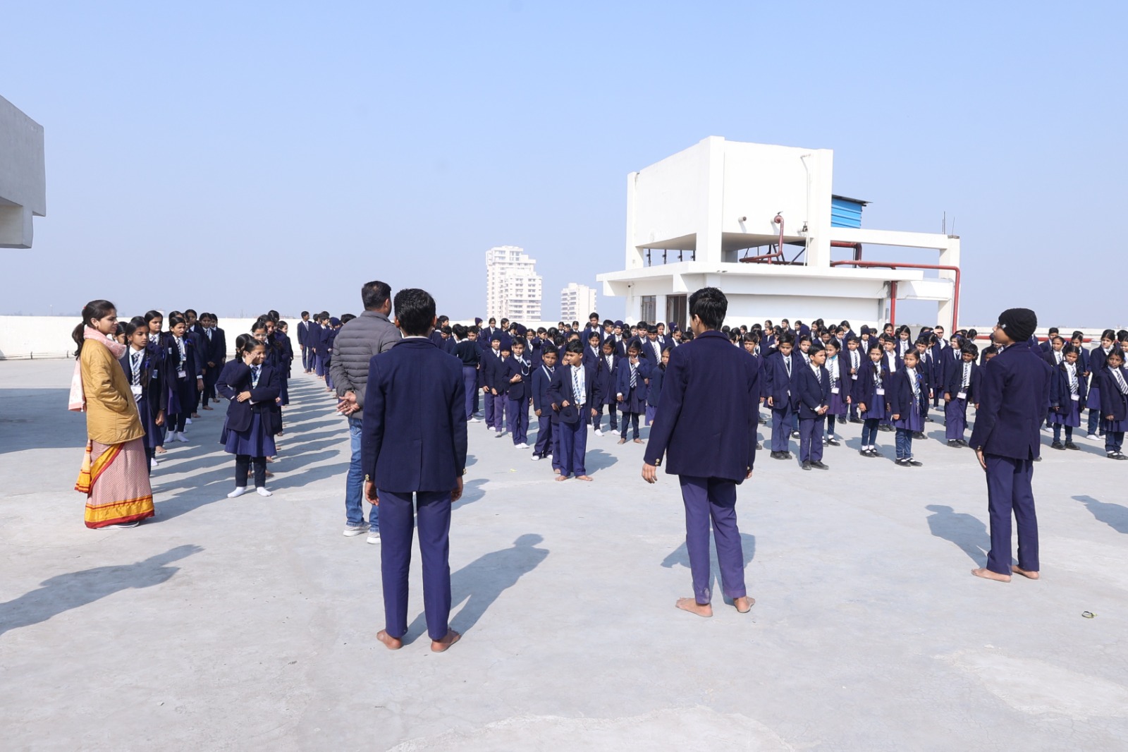 Wide rooftop view of the morning circle assembly with long shadows