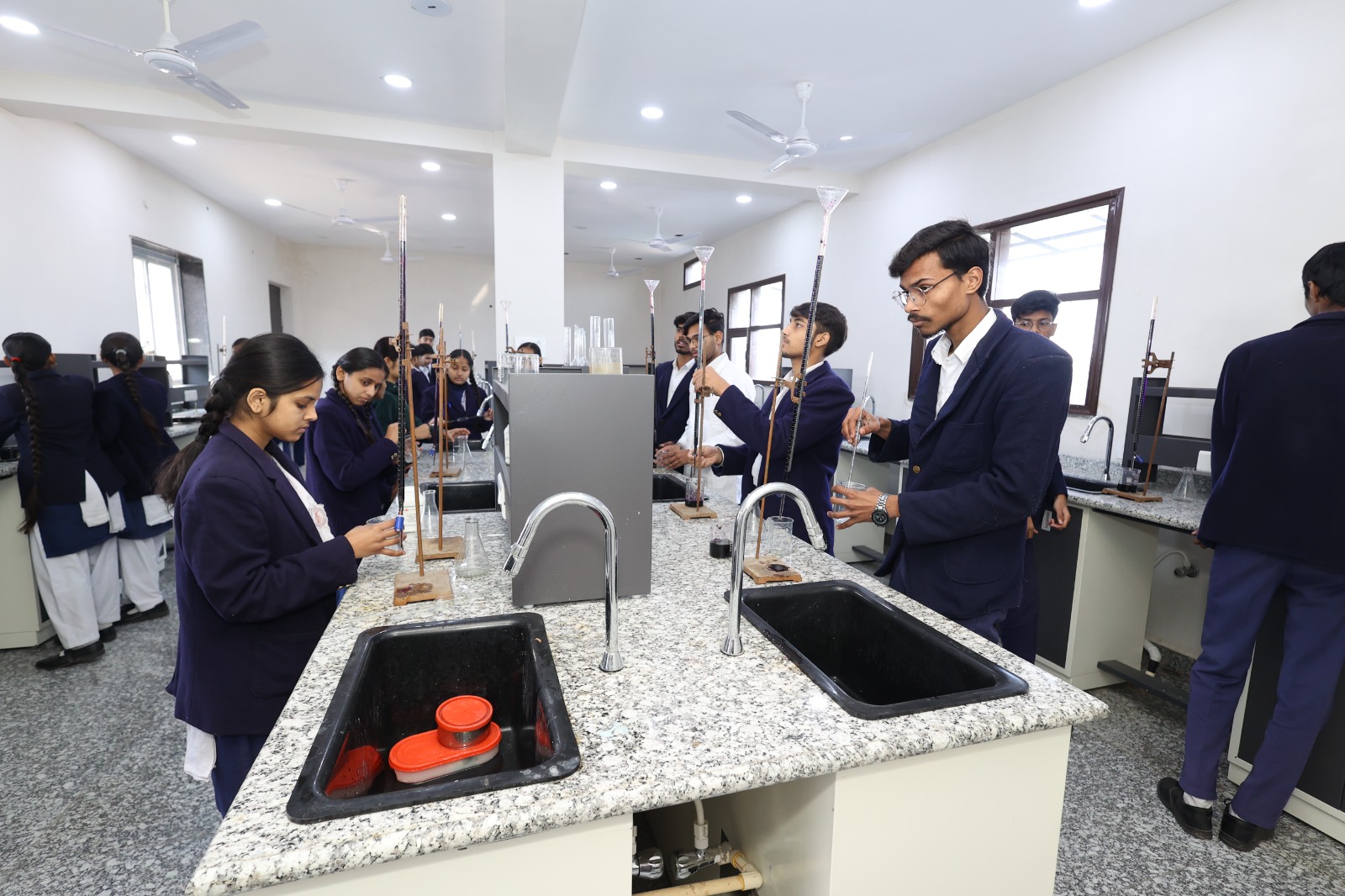 Senior students working at granite-topped chemistry benches